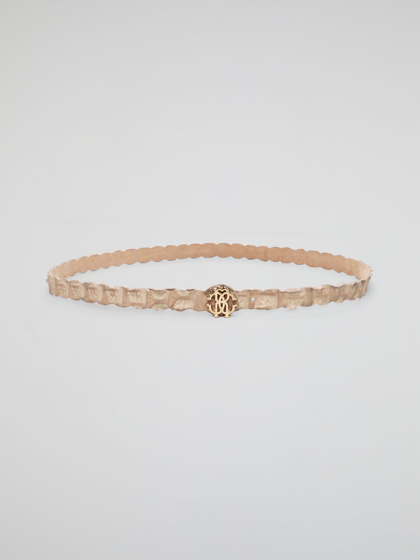 Elevate your everyday look with the timeless sophistication of the Beige Logo Buckle Belt from Roberto Cavalli. Crafted from luxurious leather, this accessory features a sleek and stylish logo buckle in a classic beige hue. Perfect for adding a touch of designer flair to any outfit, this belt is a must-have for fashion-forward individuals.