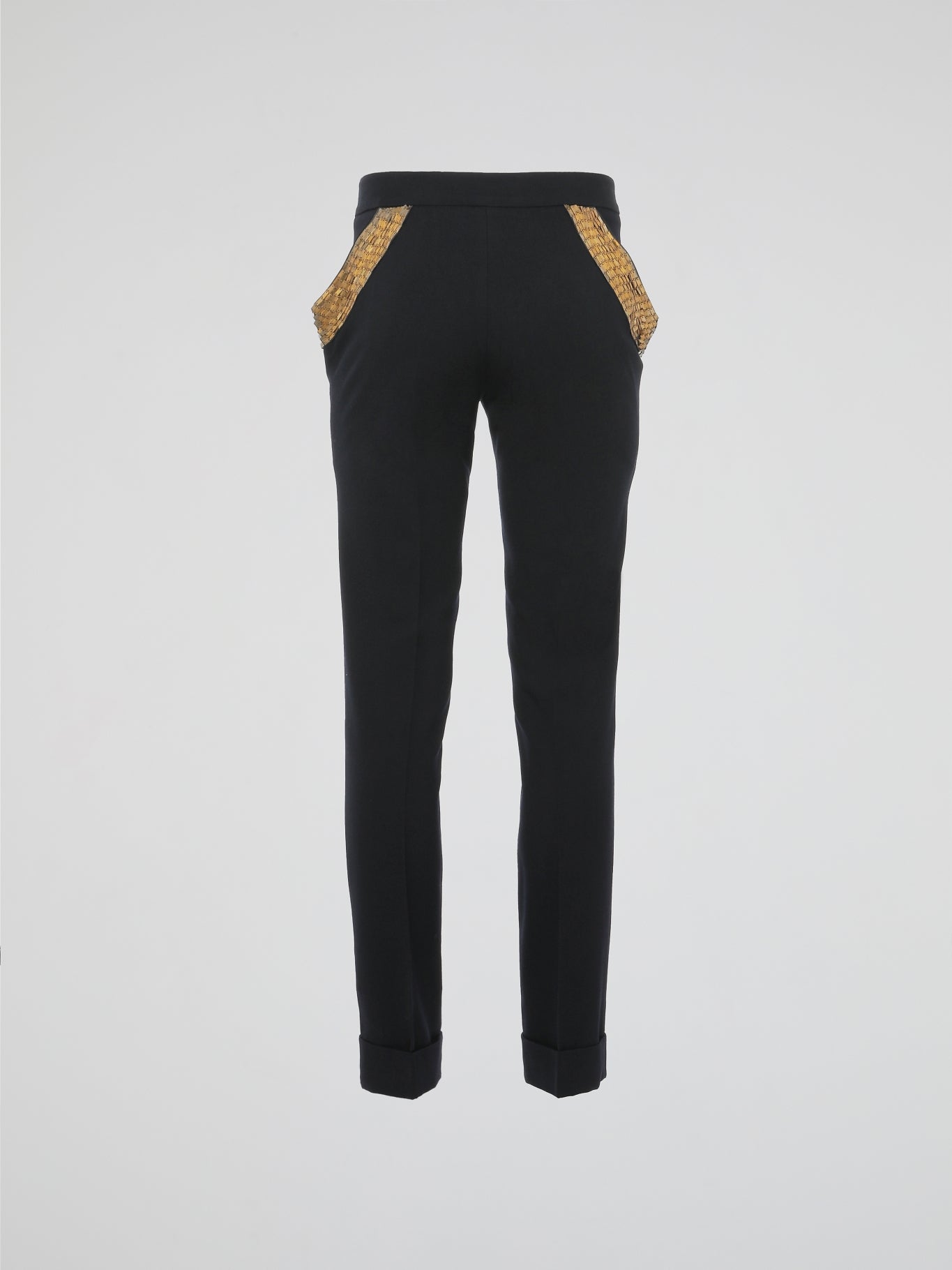 Step into elegance with these stunning Black Embellished Trousers by Roberto Cavalli. Crafted with meticulous care, each detail on these trousers tells a story of sophistication and luxury. From the delicate beaded embellishments to the figure-flattering silhouette, these trousers are a fashion statement that exudes confidence and style.