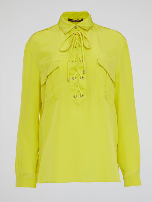 Embrace your inner rockstar with the Neon Lace Up Blouse by Roberto Cavalli, the perfect combination of edgy and sophisticated. With its bold neon color and sexy lace-up detailing, this top is sure to turn heads wherever you go. Pair it with your favorite leather pants for a look that screams fierce and fabulous.