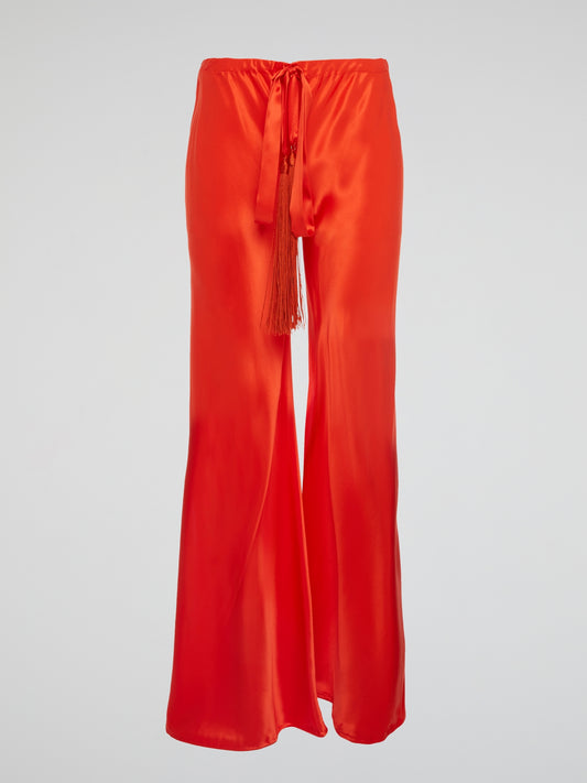 Unleash your inner goddess with these stunning Red Silk Palazzo Pants by Roberto Cavalli. Walk confidently in the flowing silk fabric that drapes elegantly around your legs, exuding luxury and sophistication. Turn heads wherever you go with the bold red color that demands attention and leaves a lasting impression.