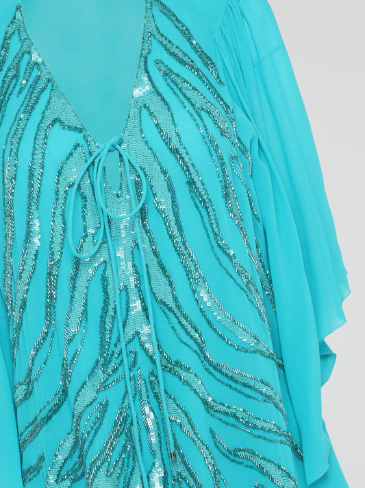 Shine like a star in the mesmerizing Blue Sequin Detailed Kaftan by Roberto Cavalli. This stunning piece features intricate sequin embellishments that capture the light and glimmer with every move you make. Perfect for a beach getaway or a special occasion, this kaftan exudes luxury and glamour, ensuring all eyes are on you wherever you go.