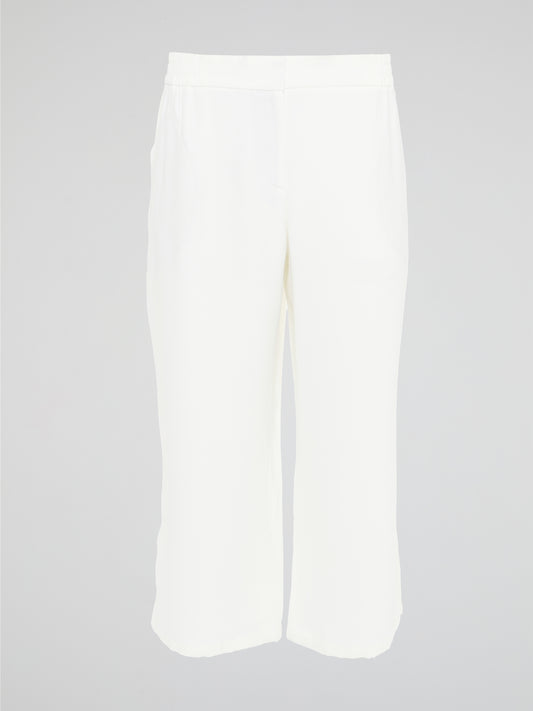 Introducing the ultimate embodiment of chic and comfort - the White Wide Leg Cropped Pants by Akris Punto. Crafted with meticulous attention to detail, these pants effortlessly blend sophistication and versatility, making them the perfect addition to any fashionista's wardrobe. Whether you're strolling on sandy beaches or attending a high-profile event, these pants will elevate your style game with their impeccable tailoring and striking silhouette.