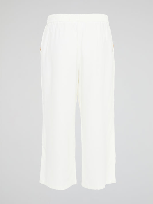 Introducing the ultimate embodiment of chic and comfort - the White Wide Leg Cropped Pants by Akris Punto. Crafted with meticulous attention to detail, these pants effortlessly blend sophistication and versatility, making them the perfect addition to any fashionista's wardrobe. Whether you're strolling on sandy beaches or attending a high-profile event, these pants will elevate your style game with their impeccable tailoring and striking silhouette.