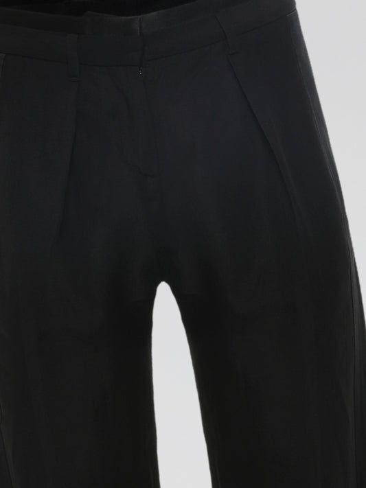 Step into the world of effortless glamour with these Black Flared Trousers by Roberto Cavalli. Crafted with meticulous precision, these trousers boast a striking silhouette that elegantly skims the figure, accentuating every curve. From the office to a night out, these trousers are a timeless wardrobe staple designed to make a bold fashion statement.