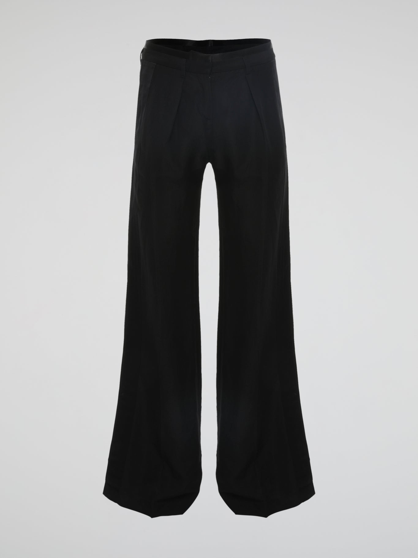 Step into the world of effortless glamour with these Black Flared Trousers by Roberto Cavalli. Crafted with meticulous precision, these trousers boast a striking silhouette that elegantly skims the figure, accentuating every curve. From the office to a night out, these trousers are a timeless wardrobe staple designed to make a bold fashion statement.