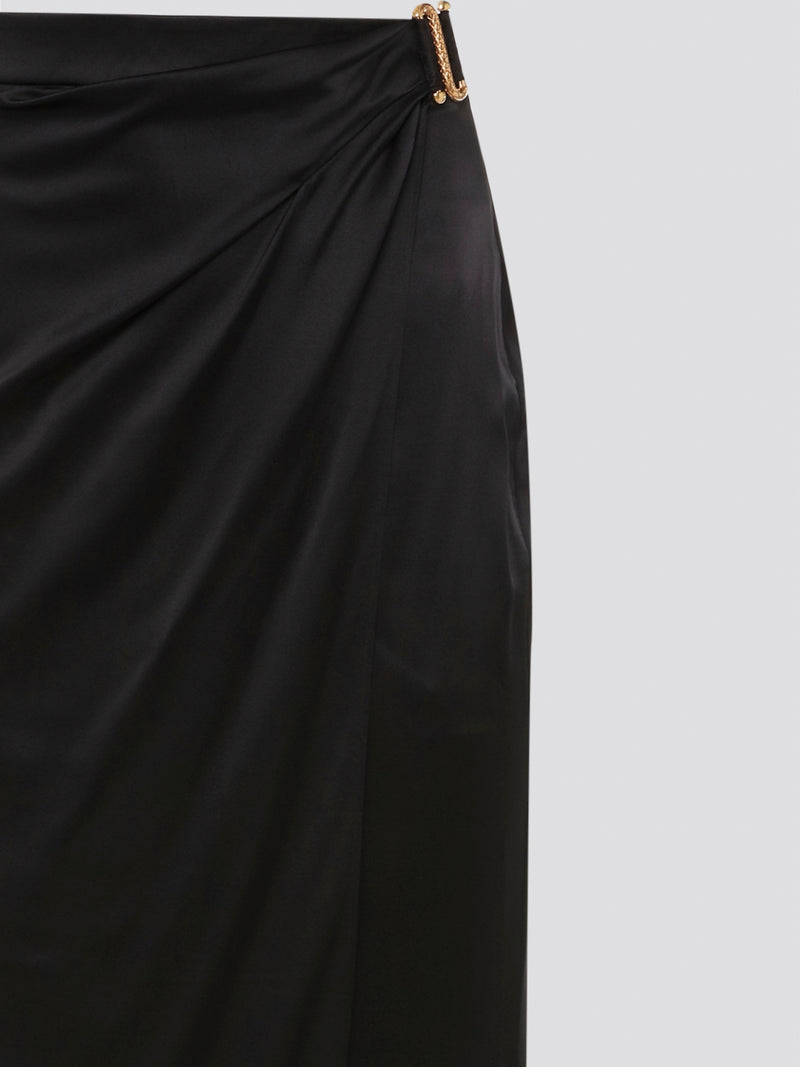 Indulge in effortless sophistication with the Black Draped Maxi Skirt by Roberto Cavalli. Made from luxurious, flowy fabric, this skirt drapes gracefully to create a flattering silhouette that exudes elegance. Whether you're heading to a black-tie event or a casual day out, this skirt will elevate your style with its timeless appeal.