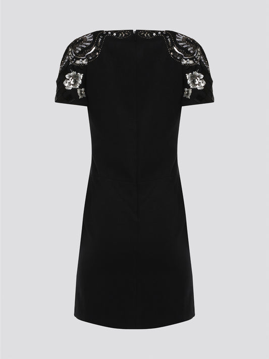 Step out in style and sophistication with our Black Embellished Plunge Dress by Roberto Cavalli. This stunning piece features intricate beadwork and shimmering embellishments that are sure to turn heads. The plunging neckline adds a touch of allure, making it the perfect choice for your next special occasion. Elevate your wardrobe with this show-stopping dress that exudes luxury and glamour.