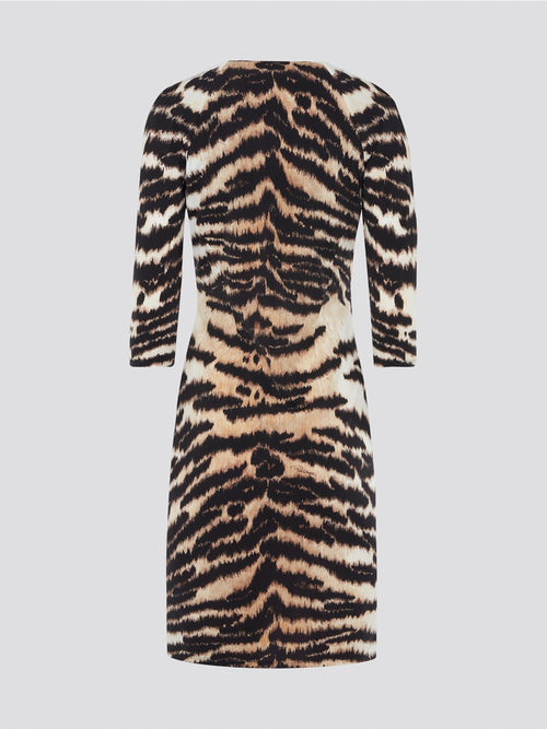 Step into the wild side with this alluring brown animal print plunge dress by Roberto Cavalli. The sleek silhouette perfectly accentuates your curves while the striking print adds a touch of bold elegance. Whether you're hitting the town or attending a special event, this dress is sure to turn heads and make a statement.