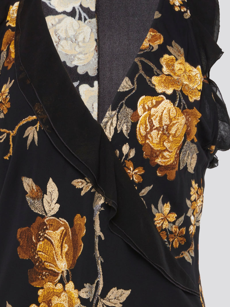 Indulge in the opulence of the Black Foliage Wrap Dress by Roberto Cavalli, a stunning blend of elegance and edge. The striking foliage pattern and flattering wrap silhouette create a sophisticated look that is perfect for any special occasion. Channel your inner fashionista and turn heads wherever you go in this statement-making piece.