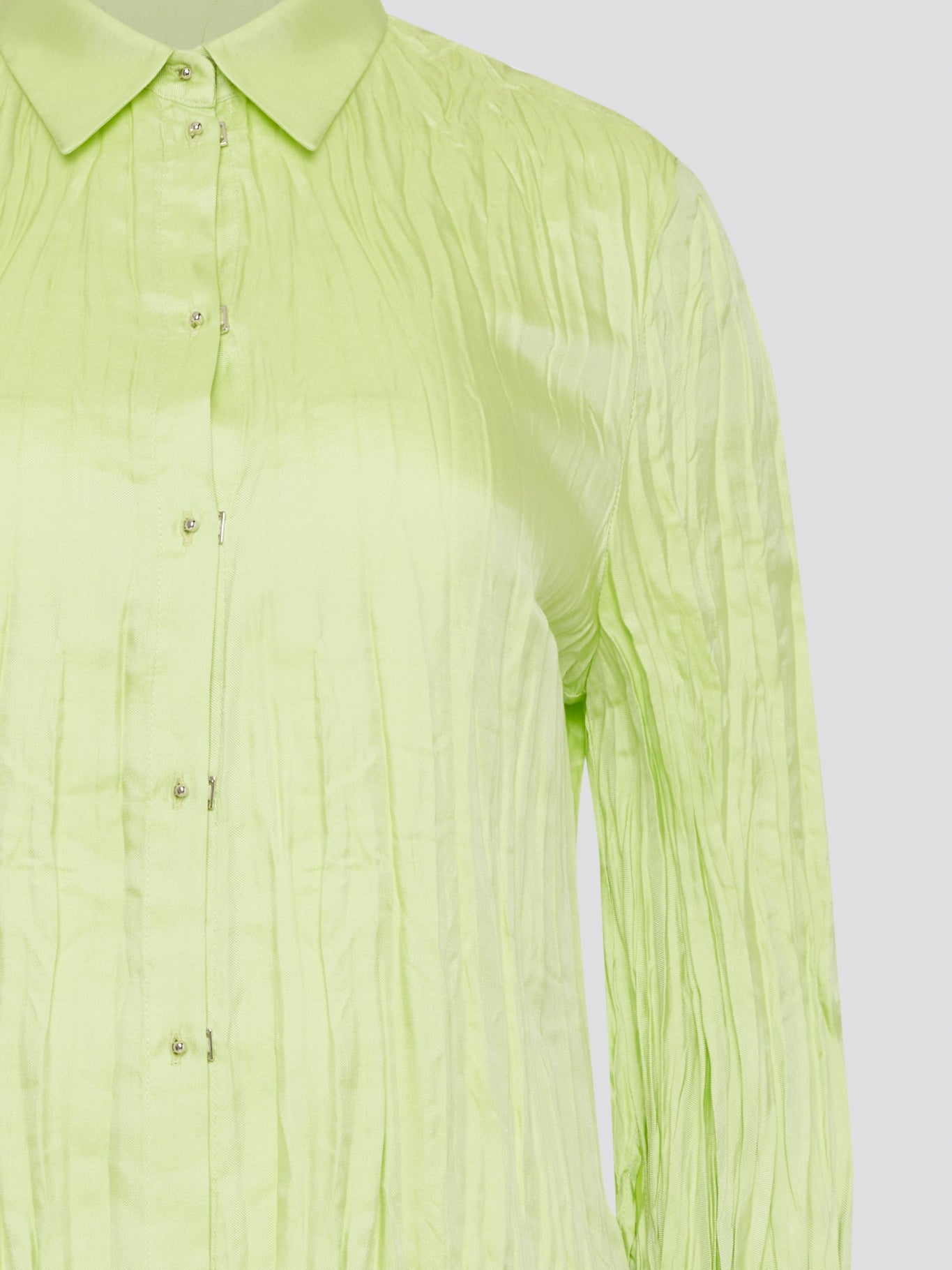 Step into the wild side with this striking green crinkled shirt from Roberto Cavalli. The vibrant hue and unique texture of the fabric will ensure you stand out from the crowd wherever you go. Embrace your fearless fashion sense and unleash your inner style icon with this must-have statement piece.