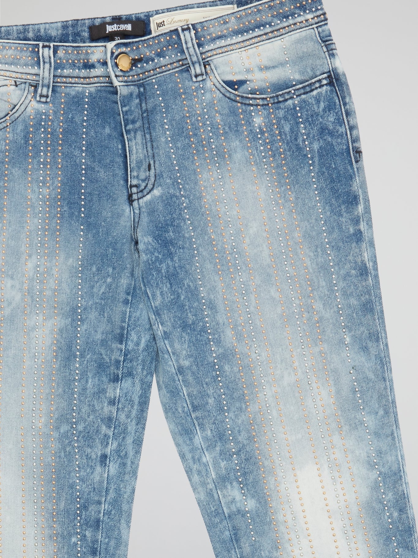 Step out in bold style with these Acid Wash Studded Jeans by Just Cavalli. The acid wash effect adds a touch of vintage cool, while the studded embellishments bring a modern edge to the classic denim design. Perfect for adding an edgy flair to any outfit, these jeans are sure to turn heads wherever you go.